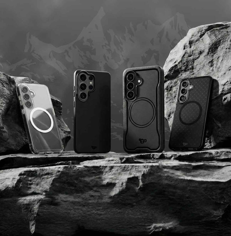 Four Samsung S26 devices in Tech21 cases sit on a rock in front of a mountain range